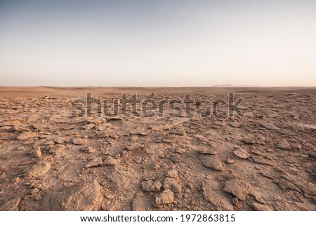 Flat rocky ground in Saudi Arabia Royalty-Free Stock Photo #1972863815