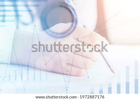 manager finance business graph icon concept,businessman hand fills documents in office,signs contracts against background of corporate profit growth charts,team building analysis in trading companies