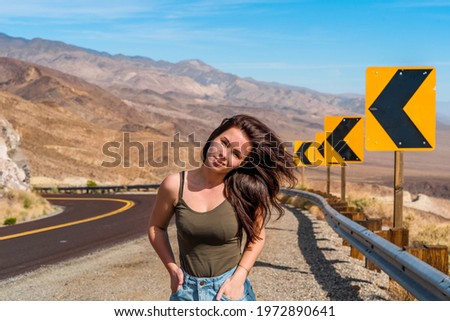 A young woman walks through the Valley of Death with picturesque landscapes
