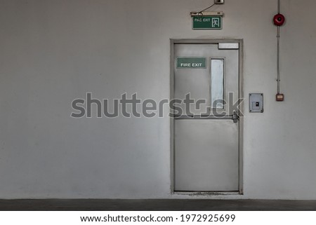 Fire exit door for emergency case with alarm for safety protection of the car parking  building near the Condominium building. Safety first concept, Copy space, Selective focus.