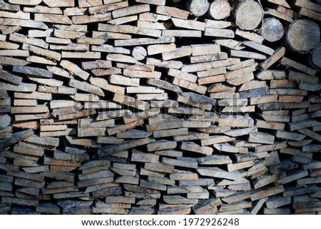  The ends of the stacked firewood for a fireplace or barbecue. Texture. Background                              