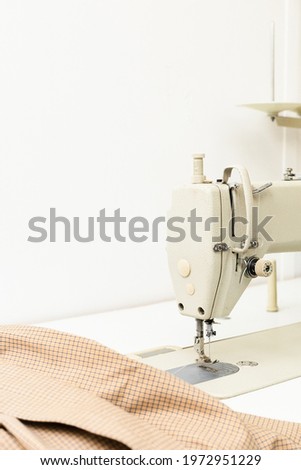Sewing machine and fabric on a light background