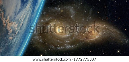 Galactic disaster - Collision of two galaxies planet earth in the foreground "Elements of this image furnished by NASA"
