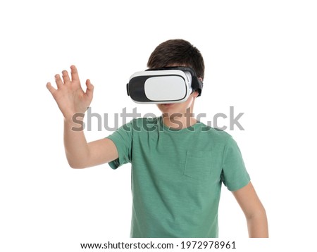Teenage boy using virtual reality headset on white background