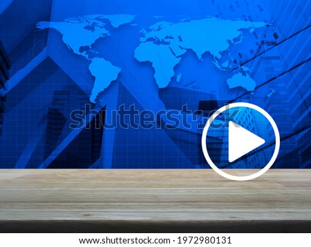 Play button on wooden table over world map, modern city tower and skyscraper, Business music online concept, Elements of this image furnished by NASA
