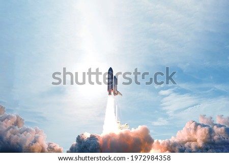 Rocket launch, with smoke and fire. Elements of this image were furnished by NASA. High quality photo Royalty-Free Stock Photo #1972984358