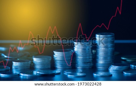 Double exposure of money coin, stock market or forex trading graph and candlestick chart suitable for financial investment concept. 