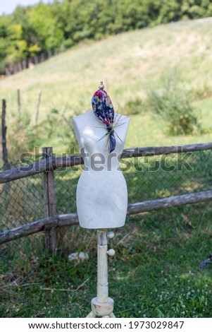 beautiful colored scarf worn around the neck of a dressmaker's mannequin. High quality photo