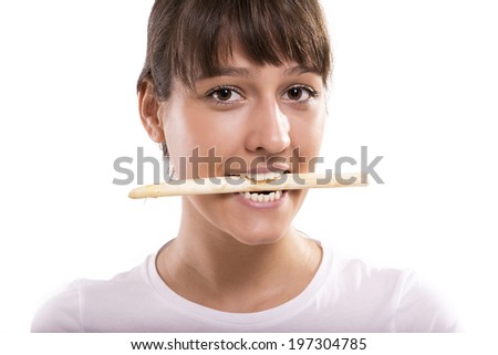 Asparagus in woman's mouth. Isolated picture.