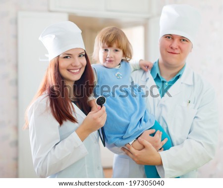 friendly doctors with child in medical clinic Royalty-Free Stock Photo #197305040