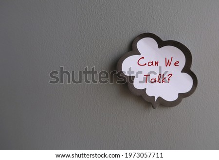 Word balloon note on gray wall written CAN WE TALK? - concept of boss , manager, family or friends approaches with a direct ask to have a serious talk about some issues Royalty-Free Stock Photo #1973057711