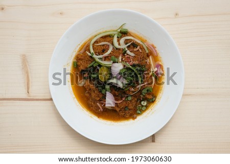 Flatlay picture of "Laksa Johor" serve during Eid Mubarak. Spaghetti in place of rice noodles, with mince fish curry and coconut milk added at certain vendors.