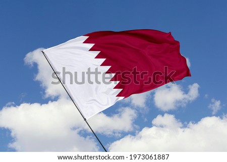 Qatar flag isolated on sky background with clipping path. close up waving flag of Qatar. flag symbols of Qatar.