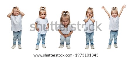 Cute little girl 2-3 years old in jeans with different emotions. Collage. Isolated on a white background. Panorama format. Royalty-Free Stock Photo #1973101343