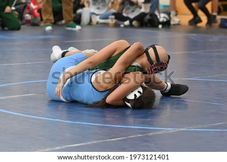 High School female wrestlers competing at a wrestling meet