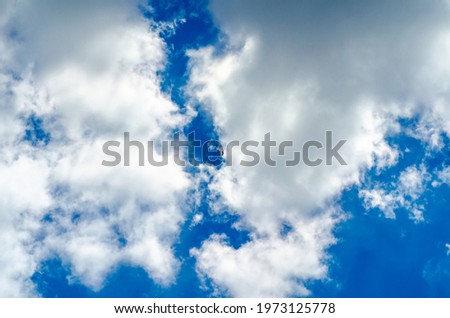 Thick white clouds on a background of blue sky