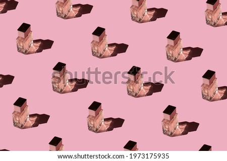 Fragnance parfume pattern. Bottles of pink woman perfume on a pastel pink background, top view. Mockup of fragrance perfume. Trendy sunlight minimal concept.

 Royalty-Free Stock Photo #1973175935