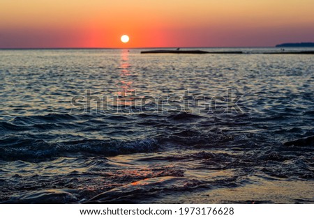 Summer sea sunset, the sun, waves and clouds, beautiful dramatic lighting