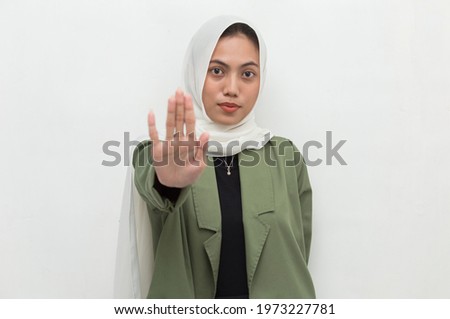 Asian muslim hijab woman show stop hands gesture
