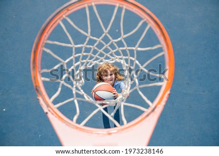 Child playing basketball. Activity and sport for kids.