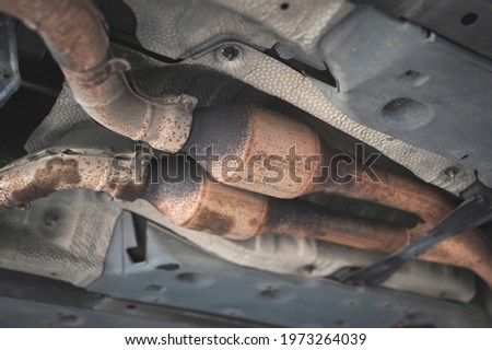 Close-up of catalytic converter in automobile exhaust system. Royalty-Free Stock Photo #1973264039