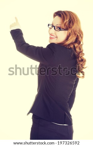 Happy success business woman pointing on copy space