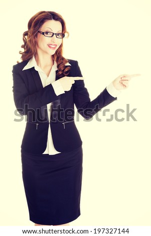 Happy success business woman pointing on copy space