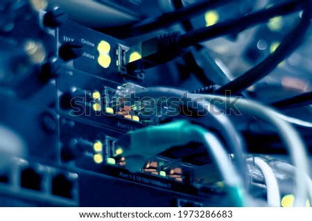 Network connection technology with network switch router, ethernet cables and status LED to show working status of data center equipment in mobile telecommunications 5G central node. Royalty-Free Stock Photo #1973286683