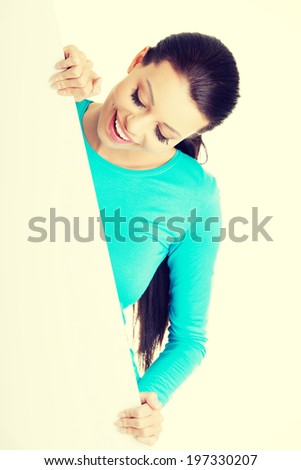 Portrait young happy woman with blank board.