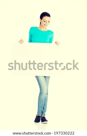 Portrait young happy woman with blank board.