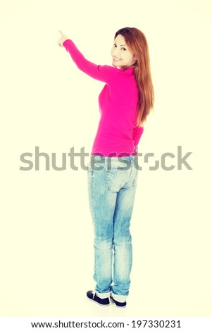Happy , excited woman pointing on copy space.