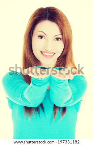Happy , excited woman presenting copy space on her palm.