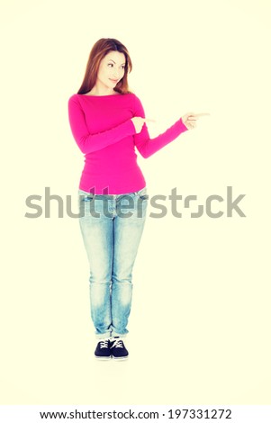 Happy , excited woman pointing on copy space.