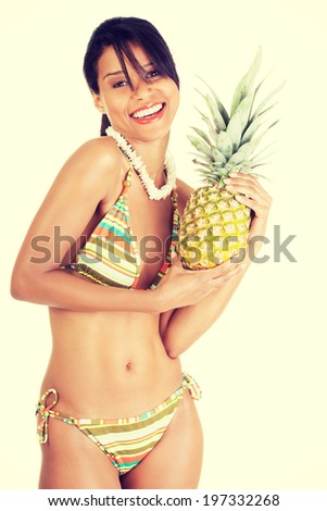 Happy summer woman in bikini with pineapple