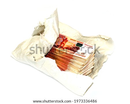 a pile of five thousandth bills of Russian rubles lie in wrapping paper