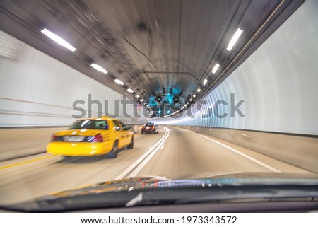 Taxi speeding up along Miami tunnel, blurred fast motion.