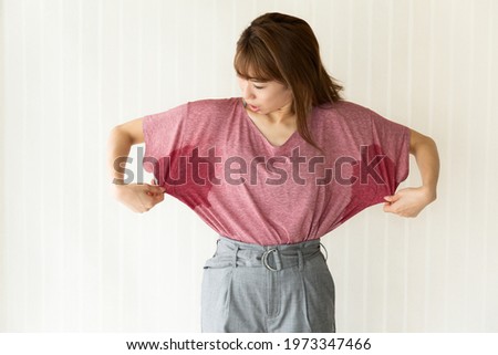 The woman is checking her armpit sweat. Royalty-Free Stock Photo #1973347466