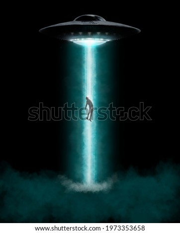 Man being abducted by UFO - alien abduction concept Royalty-Free Stock Photo #1973353658