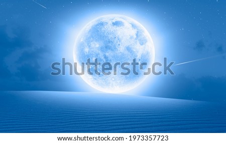 Night sky with full moon in the clouds on the foreground Long desert of sand dune "Elements of this image furnished by NASA