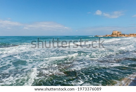Sea with waves near the coast of the old city in Caesarea Israel