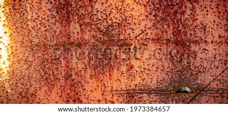 Rust on metal. Texture, background, pattern. When iron comes into contact with water and oxygen, it rusts. If salt is present, such as in seawater or salt spray, iron tends to rust more rapidly.
