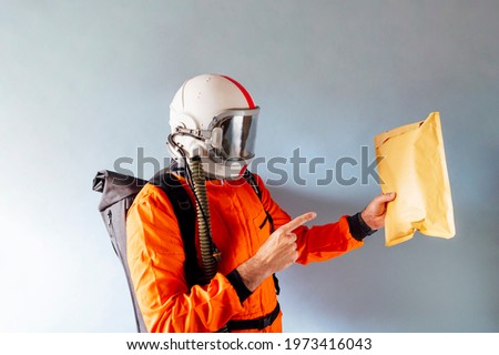 Delivery courier pointing at a package