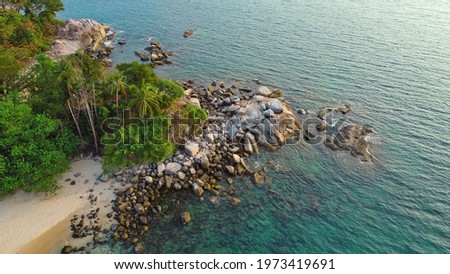Aerial drone photo of a tropical lagoon surrounded by white sand of an exotic beach and palm trees