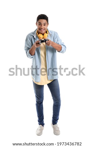 African-American teenage boy playing video game on white background