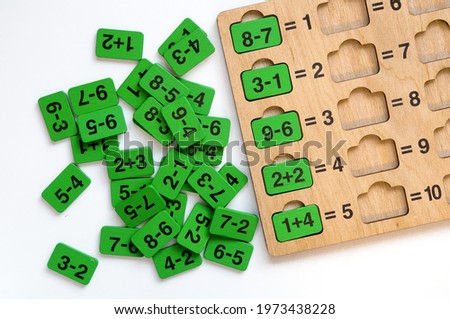 Mathematics for kids. Wooden teaching material for lessons isolated on white  background.