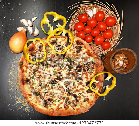 Delicious Italian pizza on sacking with vegetables: cherry tomatoes, yellow bell pepper, garlic, walnuts and onion. Copyspace, top view, flat lay, close-up
