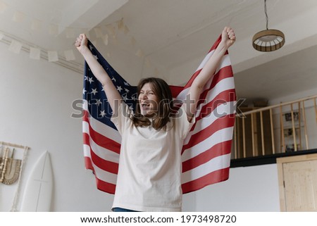 American winner. Victory. Lucky woman raises US flag
