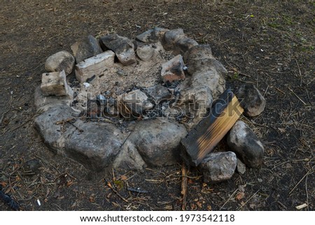 fireplace has been created with stones in a tourist recreation area in the forest.