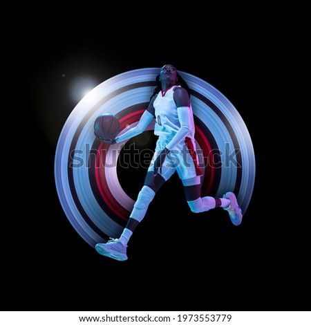 Young african female basketball player in neon on black background. Concept of motion and action in sport. Training in jump, flight. Sport, healthy lifestyle, movement, advertising. Abstract design.