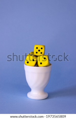 Yellow dice in an egg bowl